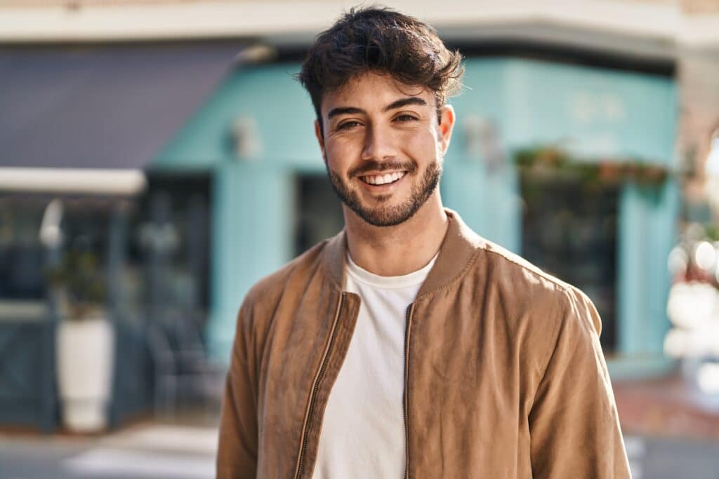 Young,Hispanic,Man,Smiling,Confident,Standing,At,Street