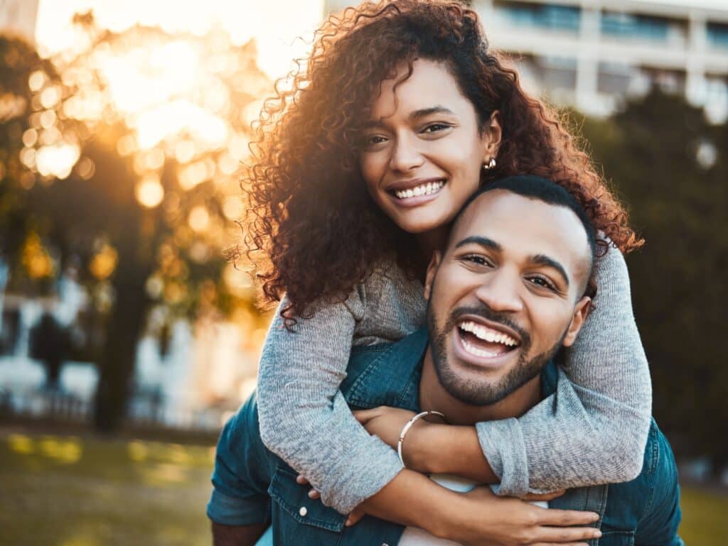 Happy,Couple,,Piggyback,And,Portrait,In,Outdoor,,Laughing,And,Relationship